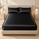 Black satin fitted sheet styled with matching pillowcases