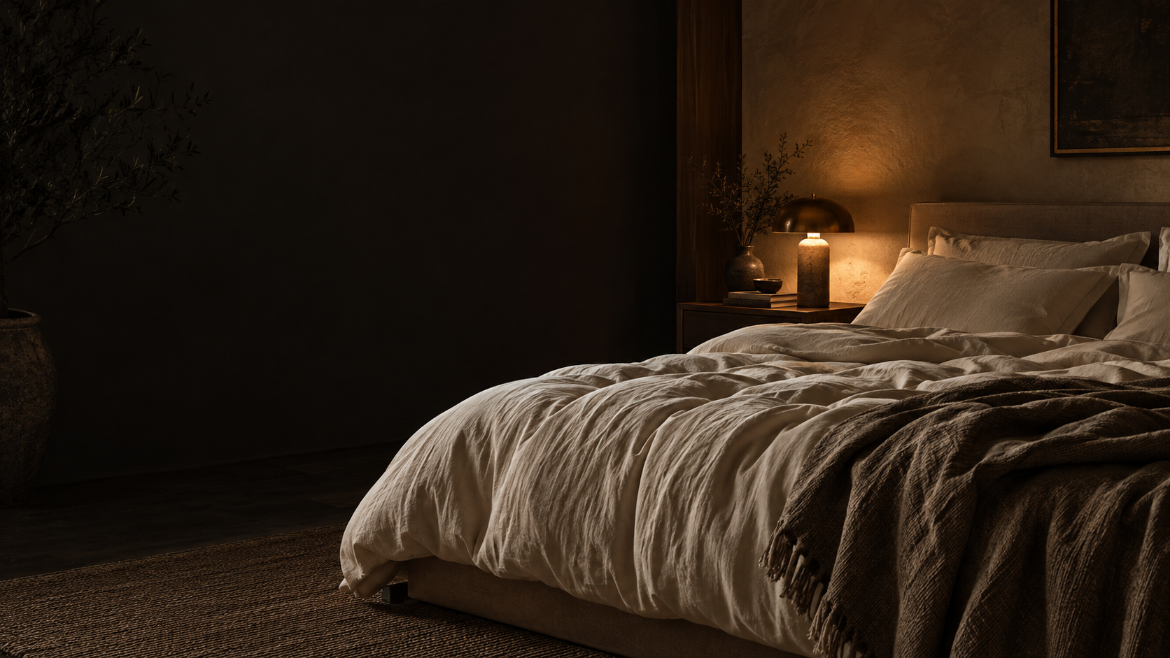 Warm bedside light and soft sheets